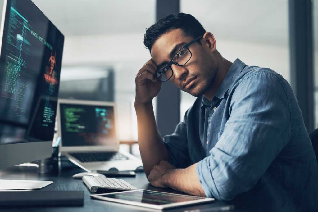 Portrait of a man using a computer in a modern office.