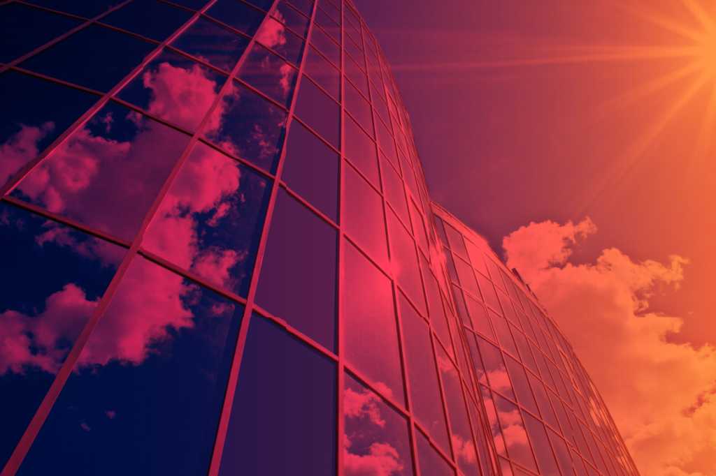 Tech Spotlight   >   Cloud [IFW / Overview]   >   Clouds reflected in a towering modern skyscraper.
